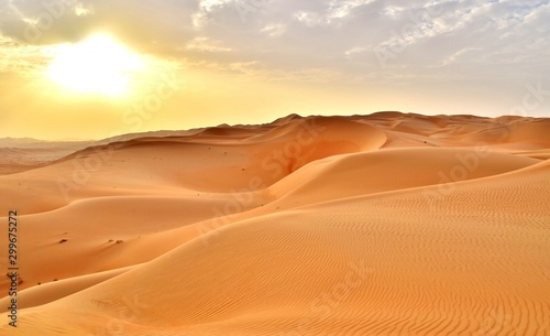 Fototapeta Naklejka Na Ścianę i Meble -  Sunset at the Edge of the Rolling Sand Dunes in the Empty Quarter (Arabian Desert) outside Abu Dhabi, United Arab Emirates
