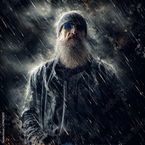 Artistic portrait of a bearded male in the rain