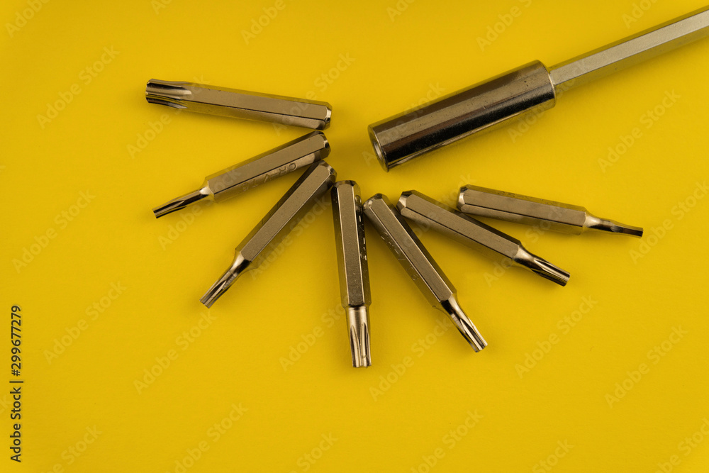 Interchangeable screwdriver set with different types of metal steel heads and bits. Isolated on white background..
