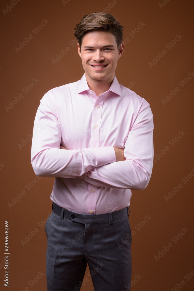 Studio shot of young handsome businessman with pink shirt Studio shot of young handsome businessman with pink shirt