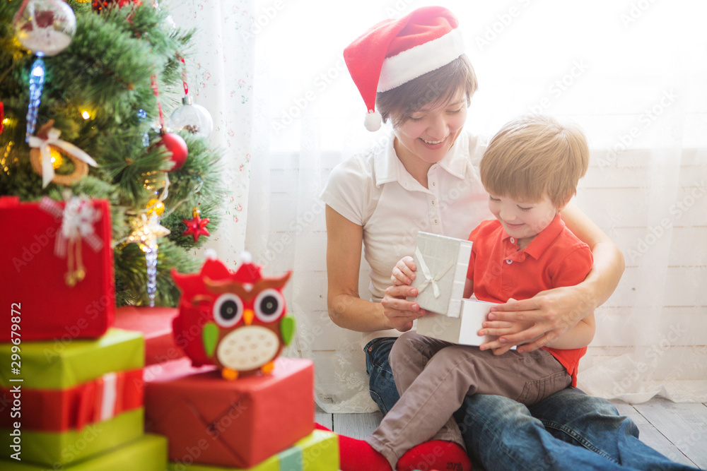 Mother giving Christmas presents to son at home Mother giving Christmas presents to son at home