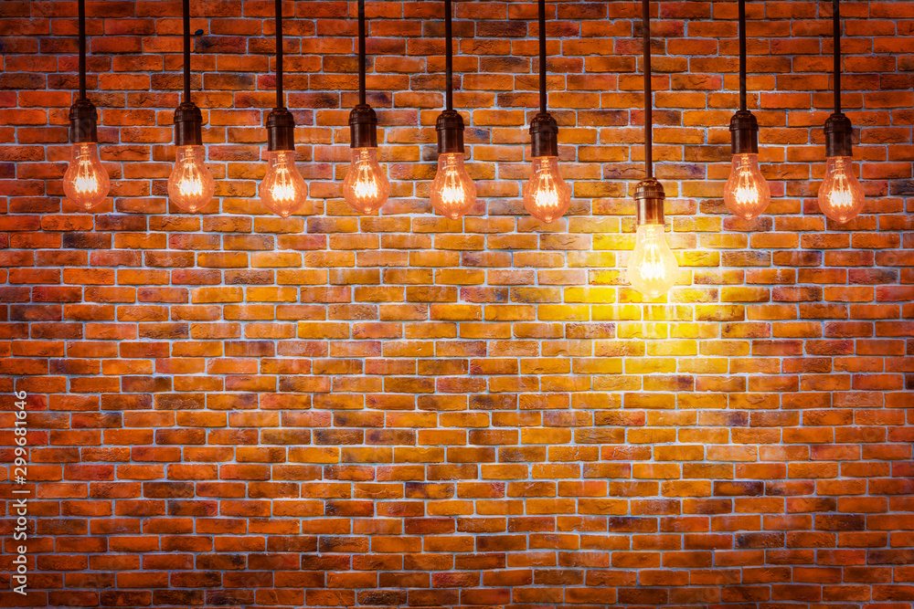 Light bulbs and vintage brick wall background with one light bulb standing  out from the rest, many good ideas and the better idea stand out concept  Stock Photo | Adobe Stock
