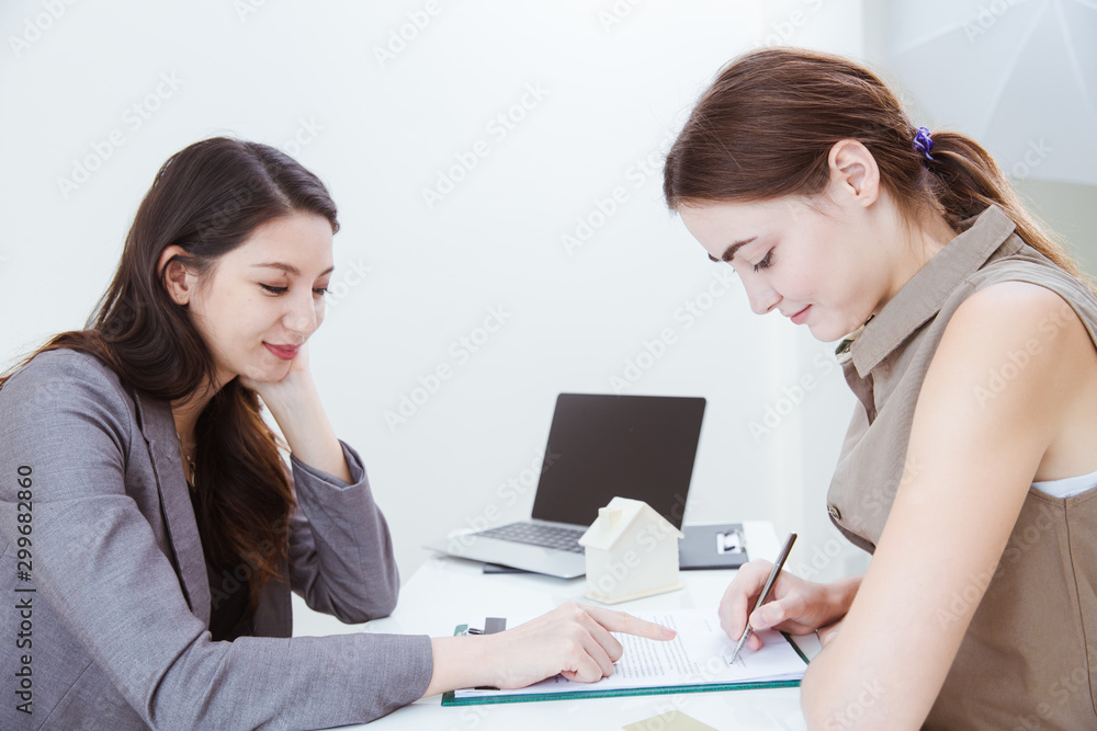 Home rental or house agency happy finish job deal with customer sign contract in the office. Home rental or house agency happy finish job deal with customer sign contract in the office.