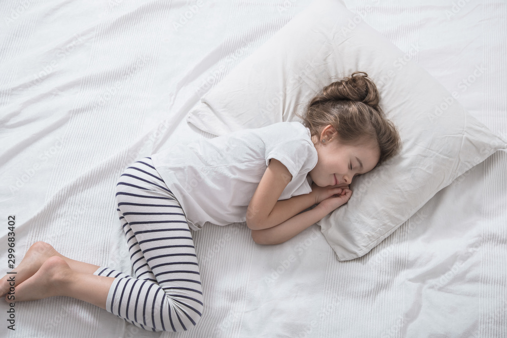 Cute little girl with long hair sleeping in bed. Cute little girl with long hair sleeping in bed.
