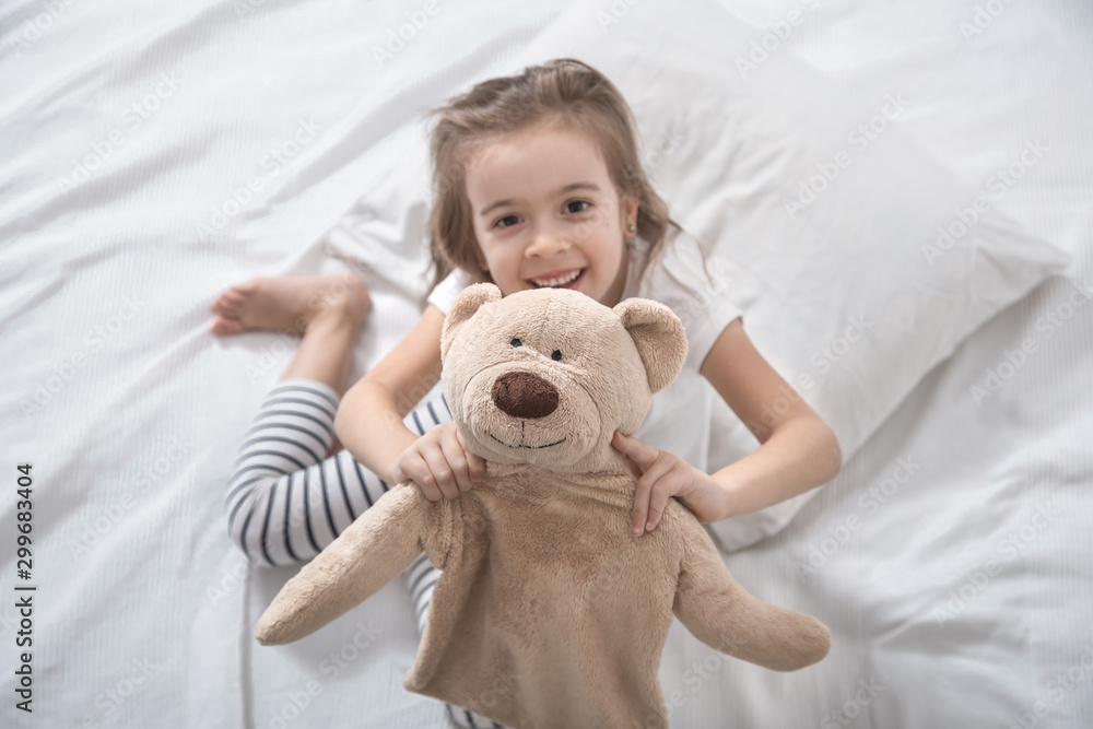 Cute little girl in bed with soft toy. Cute little girl in bed with soft toy.