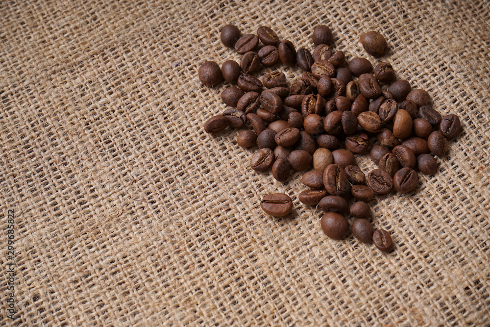 Coffee beans on jute for text background Coffee beans on jute for text background