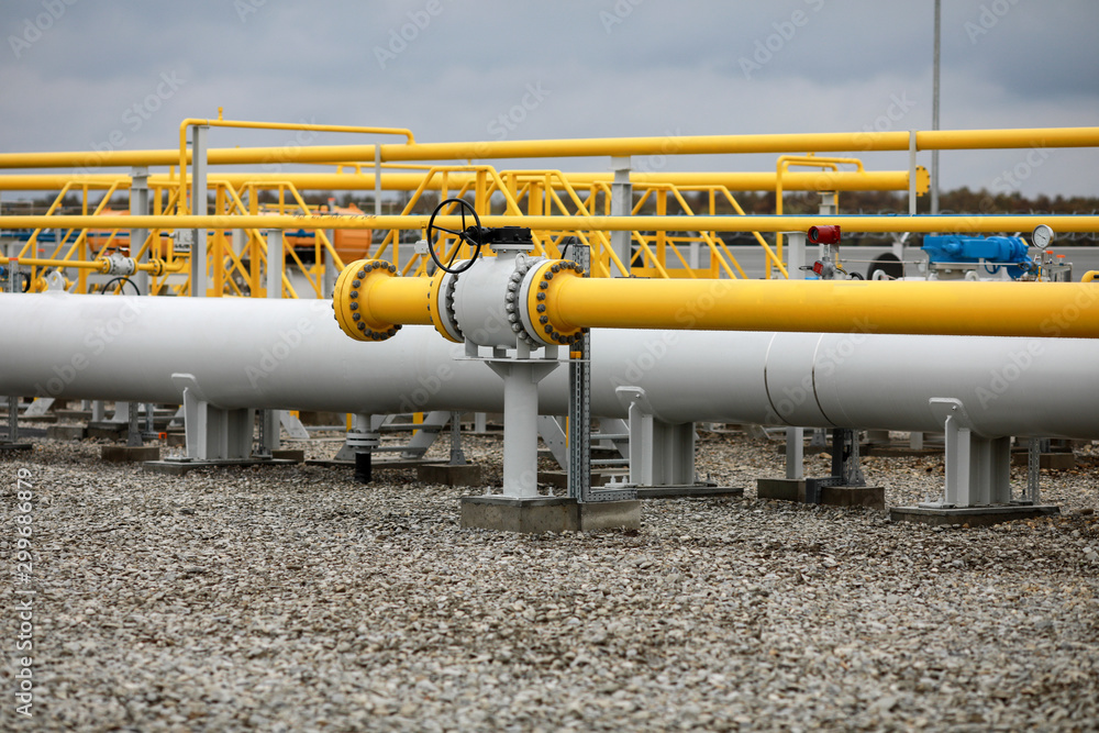 Industrial equipment (pipes, manometer/pressure gauge, levers, faucets, indicators) in a natural gas compressor station. Industrial equipment (pipes, manometer/pressure gauge, levers, faucets, indicators) in a natural gas compressor station.
