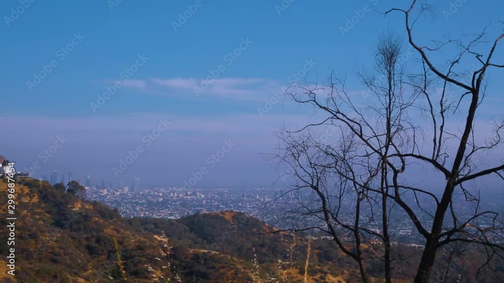 Tilt pan from sky to city of Los Angeles with Griffith Observatory in the distance. Tilt pan from sky to city of Los Angeles with Griffith Observatory in the distance.