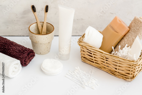 Bathroom accessories set with tooth brushes and towels on white background