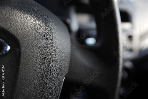 Horn icon on steering wheel of car close up