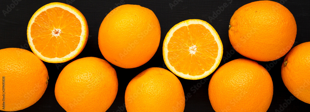 Ripe organic oranges on a black background, top view. Flat lay, overhead, from above. Close-up. Ripe organic oranges on a black background, top view. Flat lay, overhead, from above. Close-up.