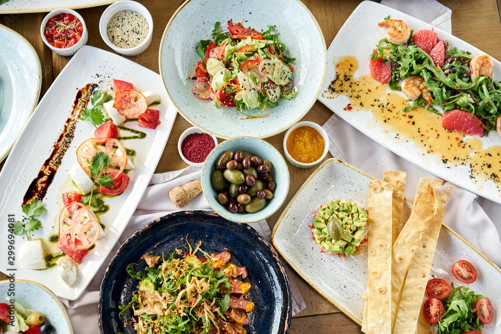 Variety of dishes on the table. Various snacks and antipasti on the table. Restaurant menu. Italian cuisine Variety of dishes on the table. Various snacks and antipasti on the table. Restaurant menu. Italian cuisine