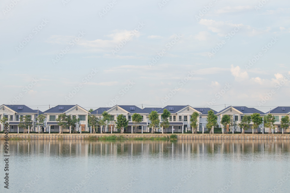Real state concept : New home or residential building under construction locate nearly lake with blue sky and sunlight in the evening time. Real state concept : New home or residential building under construction locate nearly lake with blue sky and sunlight in the evening time.