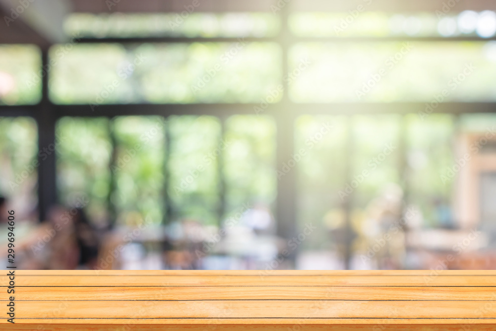 Empty wooden table with abstract blurry image of coffee shop or cafe restaurant in background for product showing and advertising. Empty wooden table with abstract blurry image of coffee shop or cafe restaurant in background for product showing and advertising.