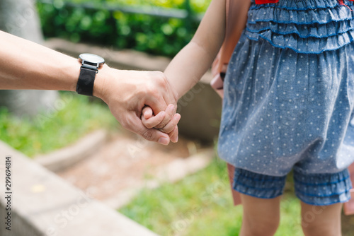 Close up of father holding his daughter hand, so sweet, family time. © makistock
