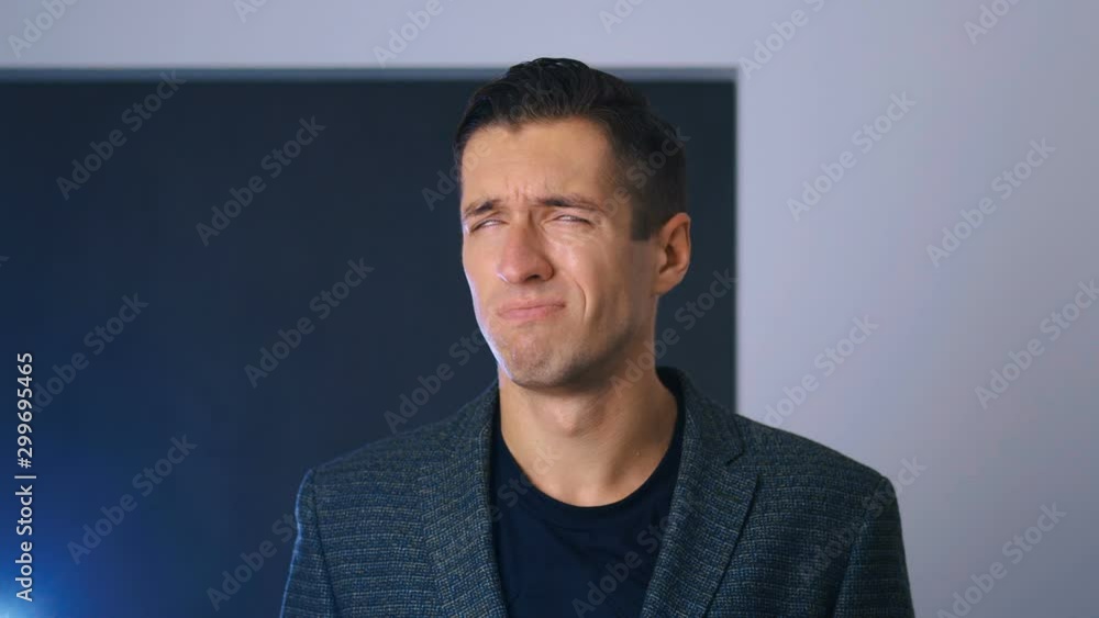 Portrait of attractive man making facepalming pose with hand. Showing an expression of dismay, exasperation, embarrassment. Businessman is disappointed and covers his face with his hand. Portrait of attractive man making facepalming pose with hand. Showing an expression of dismay, exasperation, embarrassment. Businessman is disappointed and covers his face with his hand.