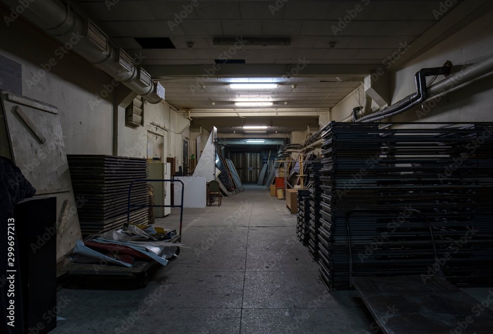 Naklejka premium Long dark corridor in an old industrial building