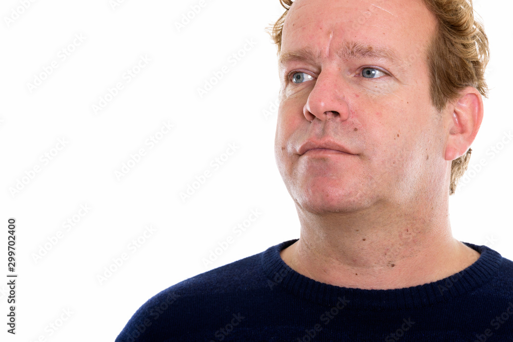 Studio shot of mature man with curly blond hair isolated against white background