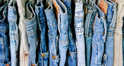 A rack of second hand jeans photo