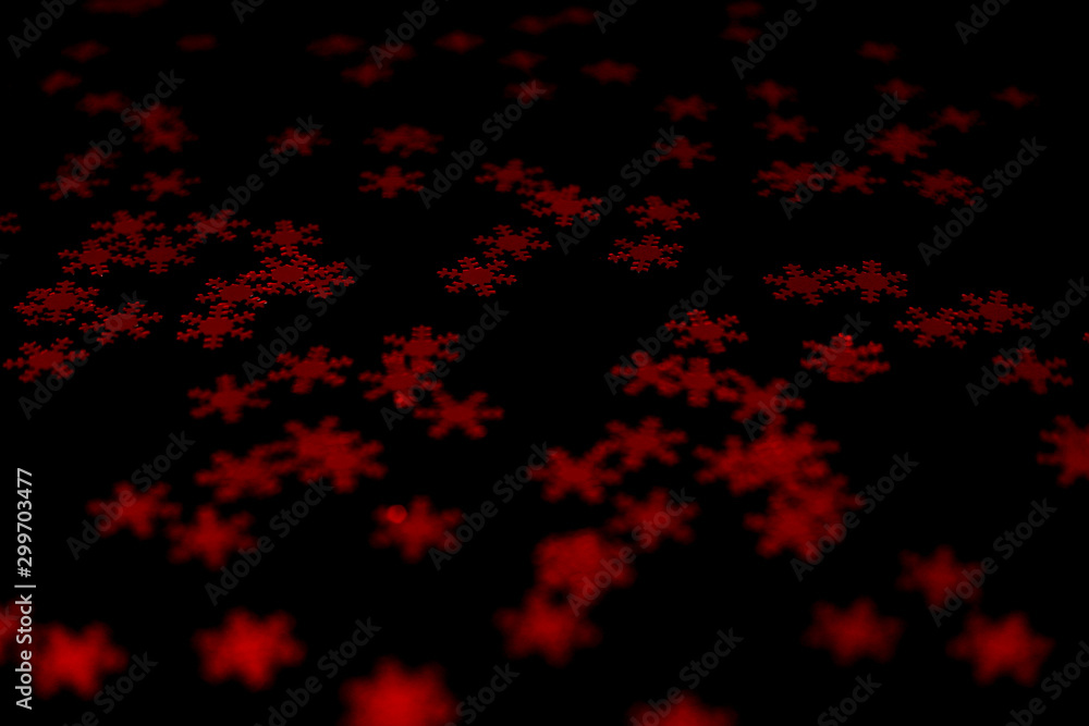 red snowflake glitter sparkle isolated on black background red snowflake glitter sparkle isolated on black background