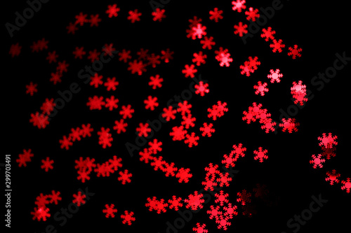 red snowflake glitter sparkle isolated on black background