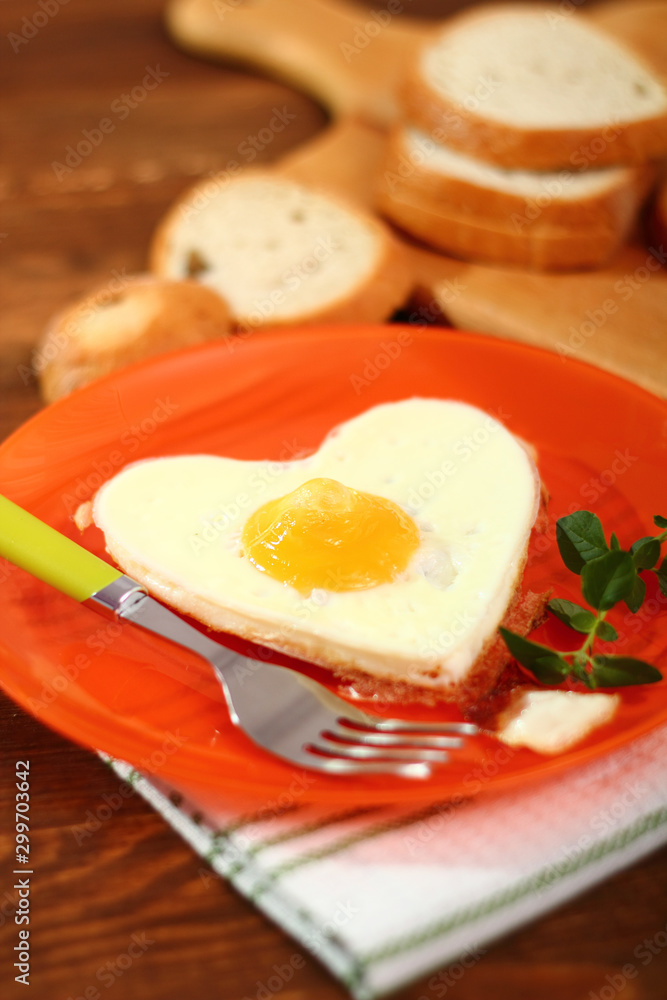 Fototapeta premium Fried Egg Sunny Side Up in Heart Shape