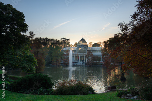 Sunset view of Crystal Palace or Palacio de cristal in Retiro Park in Madrid, Spain. The Buen Retiro Park is one of the largest parks of the city of Madrid, Spain