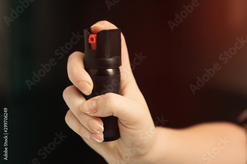 Girl hand is protected by pepper spray. Self defense concept © Илья Подопригоров