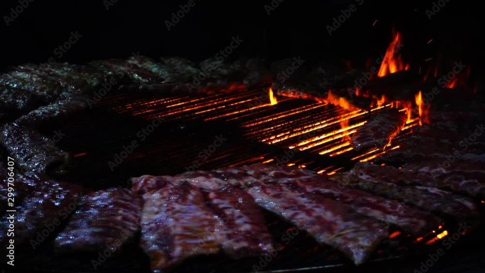 Pork ribs roast on fire, barbecue. Slow motion. Pork ribs roast on fire, barbecue. Slow motion.