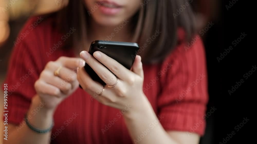 Asian woman using smart phone for social media in coffee shop. Asian woman using smart phone for social media in coffee shop.