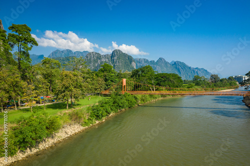 Aerial view of village Vang Vieng and Nam Song river , Laos. Southeast Asia. Photo made by drone from above. Bird eye view.