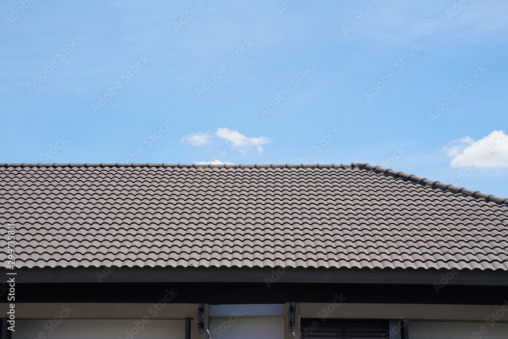 Black tile roof of construction townhouse with blue sky and cloud background. Black tile roof of construction townhouse with blue sky and cloud background.