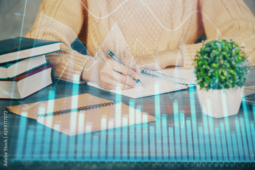 Forex graph on hand taking notes background. Concept of research. Double exposure Forex graph on hand taking notes background. Concept of research. Double exposure