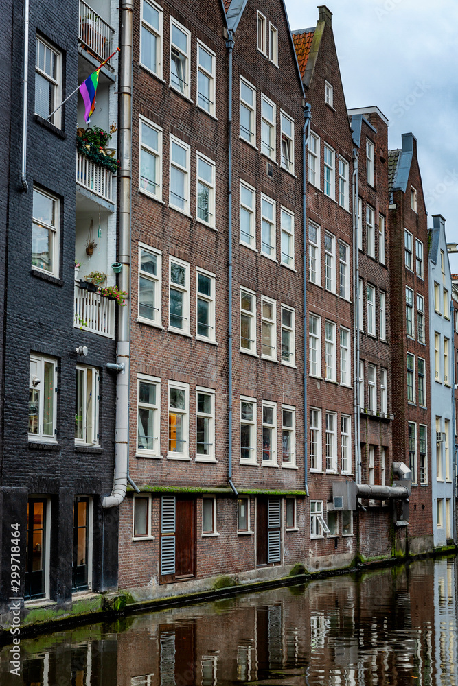 Traditional houses on the water in Amsterdam. Close-up. Vertical.