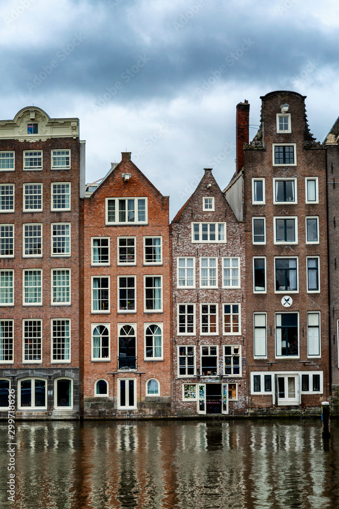 Traditional houses on the water in Amsterdam. Close-up. Vertical.