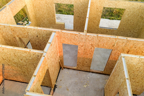 Construction of new and modern modular house. Walls made from composite wooden sip panels with styrofoam insulation inside. Building new frame of energy efficient home concept.