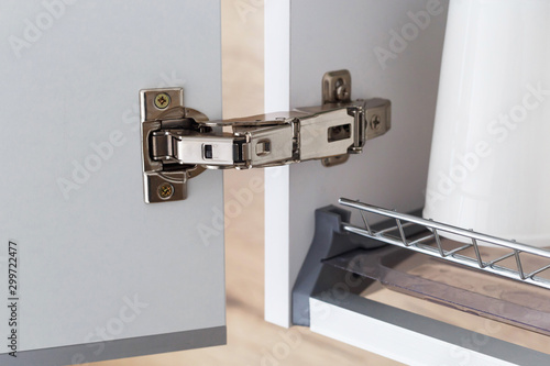 Door hinge of cabinet for drying dishes. Wide angle hinge. photo