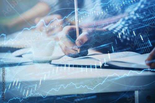 Multi exposure of two men planing investment with stock market forex chart.