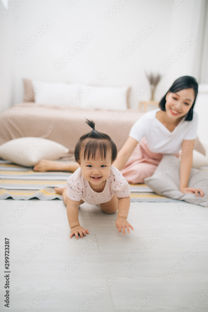 asian mother and child relaxing on the bed room asian mother and child relaxing on the bed room