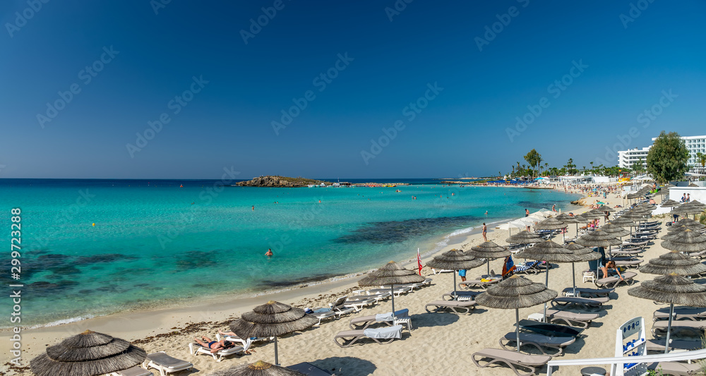 Tourists relax on the famous beach of Cyprus. Nissi Beach