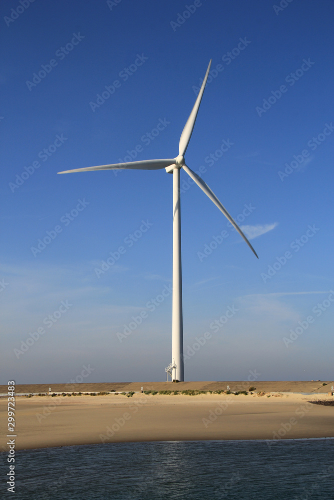 Wind turbine wings in close up in the dunes of Neeltje Jans island in the Netherlands. Wind turbine wings in close up in the dunes of Neeltje Jans island in the Netherlands.