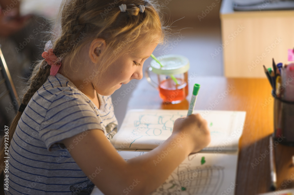 Cute little girl painting a picture in a home interior. Cute little girl painting a picture in a home interior.