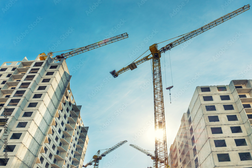 Construction site with buildings and industrial cranes