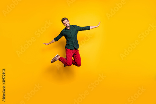 Full length body size photo of cheerful trendy man pretending to be air plane white smiling toothily beaming isolated vivid color background with hands spread