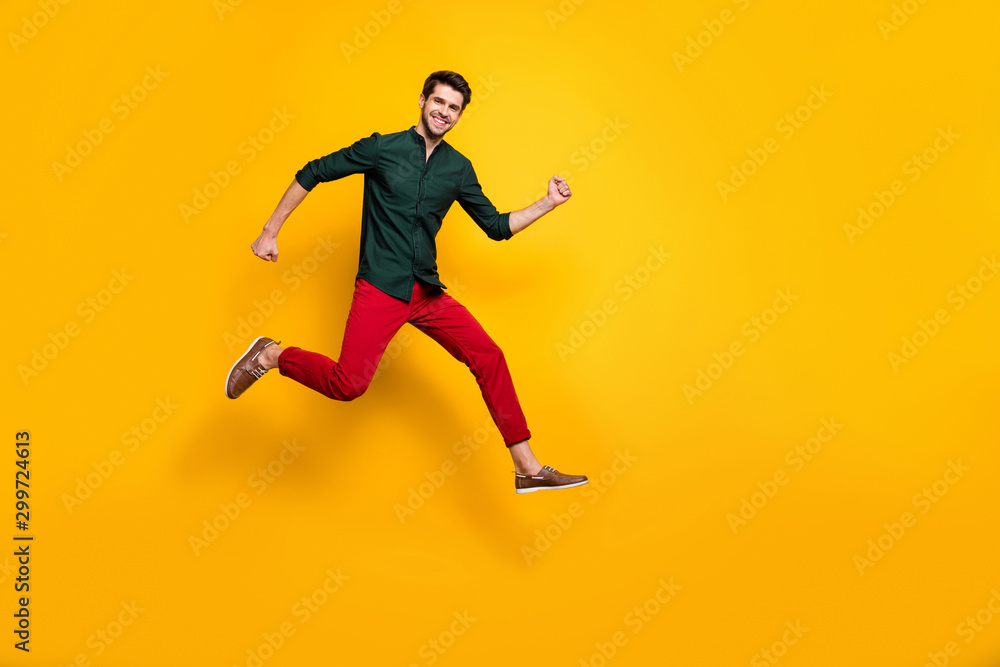 Full length body size photo of turned running jumping crazy man enjoying his run in shoes for sales in trousers isolated vivid color background