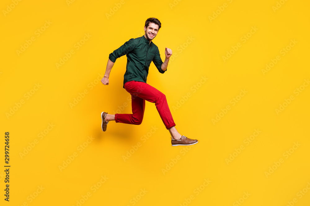 Full length body size photo of cheerful positive nice cute guy running towards shopping mall isolated vivid color background