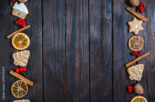 Christmas gingerbread of different kinds on a black and white wooden background