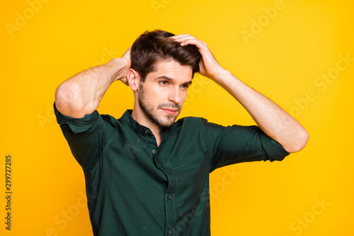 Turned photo of worried troubled man having problem of hair loss looking down disappointed with effect of newly bought shampoo isolated over vibrant color background