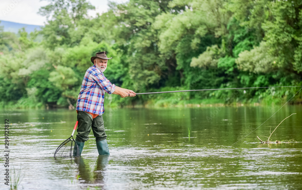 Activity and hobby. Fishing freshwater lake pond river. Happiness is rod in your hand. Senior man catching fish. Mature man fishing. Retired fisherman. Male leisure. Fisherman with fishing rod Activity and hobby. Fishing freshwater lake pond river. Happiness is rod in your hand. Senior man catching fish. Mature man fishing. Retired fisherman. Male leisure. Fisherman with fishing rod
