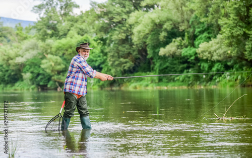 Activity and hobby. Fishing freshwater lake pond river. Happiness is rod in your hand. Senior man catching fish. Mature man fishing. Retired fisherman. Male leisure. Fisherman with fishing rod